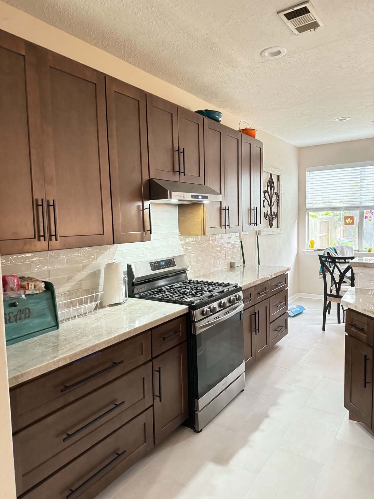 Kitchen with dark wood shaker cabinets and black bar pulls