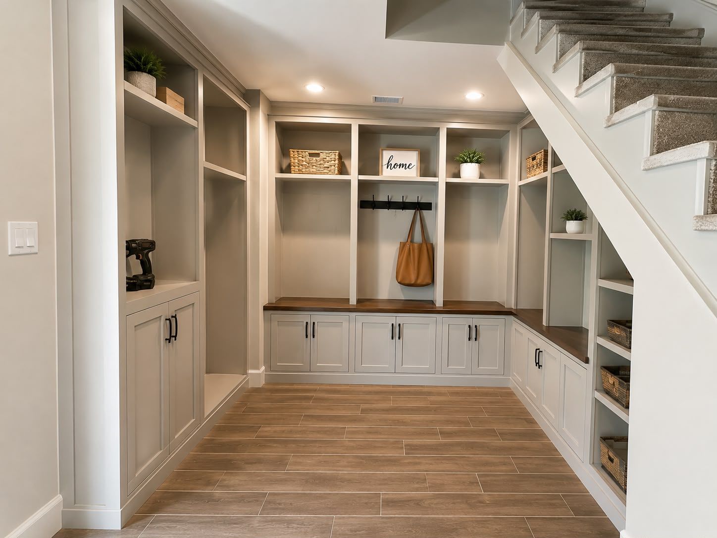 Design rendering of painted built-in cabinets and cubbies under a staircase